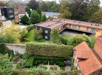 an aerial view of a building with a garden at Castelnou Aparthotel in Ghent