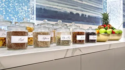 a shelf filled with jars of food and fruit at Hotel Le Plaza Brussels in Brussels