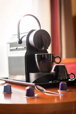 a coffee maker sitting on top of a table at Astoria Hotel Antwerp in Antwerp
