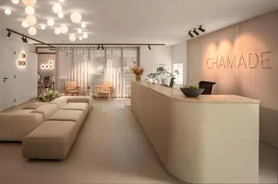 a lobby of a chanel store with a counter and chairs at Hotel Chamade in Ghent