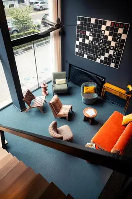 a living room with chairs and furniture on a floor at Hotel Queen Anne in Brussels