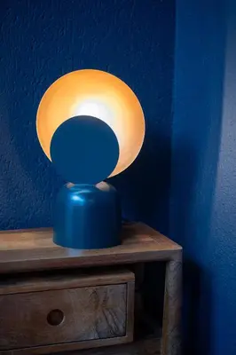 a blue lamp sitting on top of a wooden table at Hotel Queen Anne in Brussels