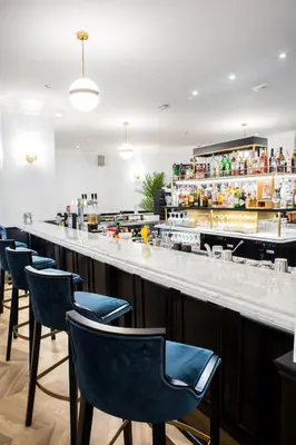a bar with blue chairs in a restaurant at a&o Brussel Centrum in Brussels