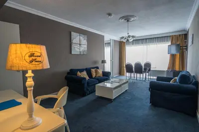 a living room with a couch and a table at First Euroflat Hotel in Brussels
