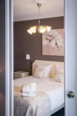 a bedroom with a bed with towels on it at First Euroflat Hotel in Brussels