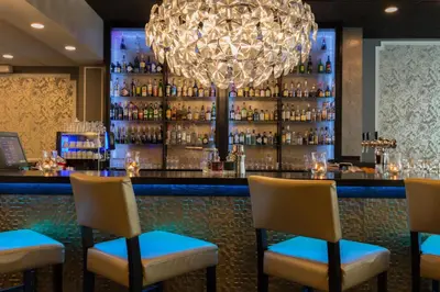 a bar with chairs and a chandelier at Thon Hotel Bristol Stephanie in Brussels
