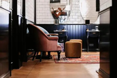 a living room with a chair and a ottoman at Craves in Brussels