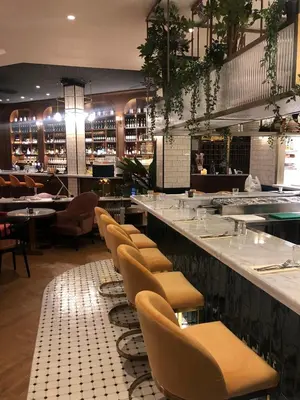 a restaurant with a row of chairs and a bar at Craves in Brussels