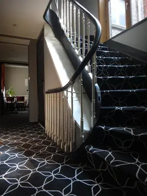 a staircase in a building with black and white carpet at Safestay Brussels Grand Place in Brussels