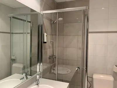 a bathroom with a shower and a sink and a toilet at Safestay Brussels Grand Place in Brussels