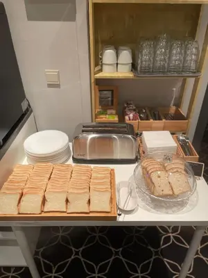 a table with breads and other items on it at Safestay Brussels Grand Place in Brussels