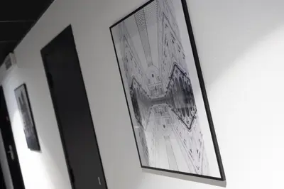a framed picture of a building on a wall at Aris Grand Place Hotel in Brussels