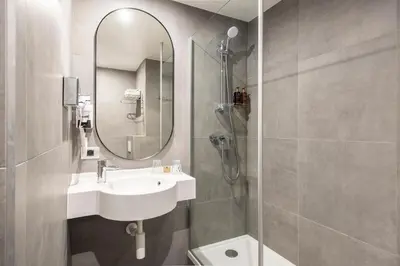a bathroom with a sink and a mirror at Aris Grand Place Hotel in Brussels