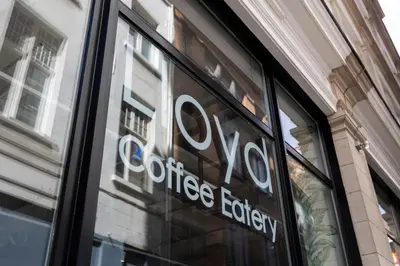 a sign in the window of a store at Aris Grand Place Hotel in Brussels