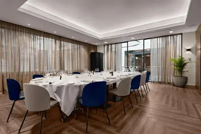a conference room with a long table and chairs at NH Brussels EU Berlaymont in Brussels