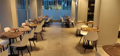a row of tables and chairs in a restaurant at Best Western Hotel Royal Centre in Brussels