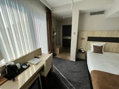 a hotel room with a bed and a window at Best Western Hotel Royal Centre in Brussels