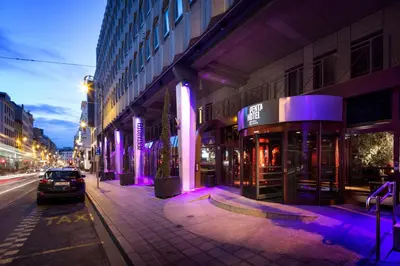 a city street at night with purple lights at pentahotel Brussels City Centre in Brussels