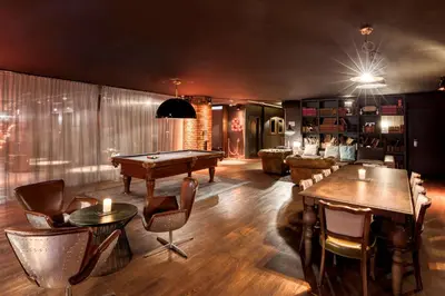a living room with a pool table and chairs at pentahotel Brussels City Centre in Brussels