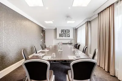 a conference room with a long table and chairs at pentahotel Brussels City Centre in Brussels