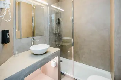 a bathroom with a sink and a shower at Hotel Corsendonk Viane in Turnhout