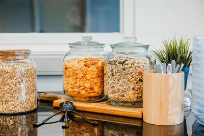four jars of granola sitting on a counter at Hotel Corsendonk Viane in Turnhout