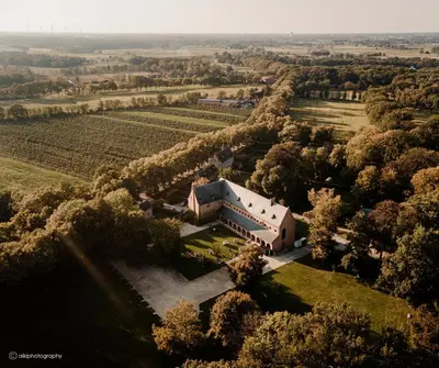 an aerial view of a large house in a field at Priorij Corsendonk in Oud-Turnhout