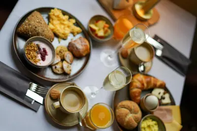 a table topped with plates of breakfast foods and drinks at Priorij Corsendonk in Oud-Turnhout
