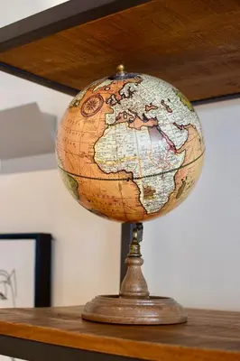 a globe sitting on top of a wooden table at Bedford Hotel Brussels in Brussels