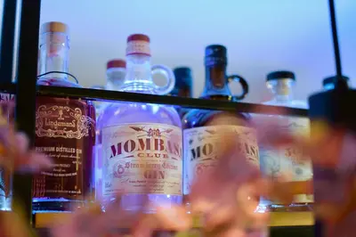a group of bottles of alcohol on a shelf at Bedford Hotel Brussels in Brussels