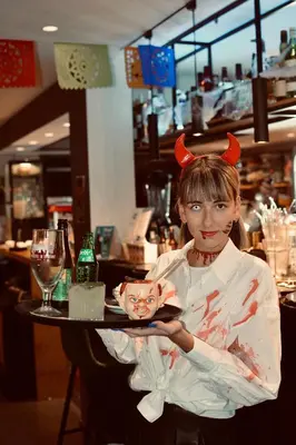 a woman holding a plate with a cat on it at Bedford Hotel Brussels in Brussels