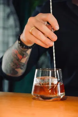 a person is holding a drink in a glass at Bedford Hotel Brussels in Brussels