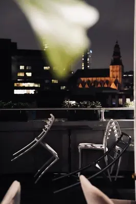 a chair sitting on a ledge with a view of a city at Bedford Hotel Brussels in Brussels