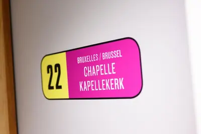 a sign on a door with pink and yellow at Hotel La Grande Cloche in Brussels