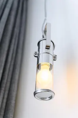 a light hanging in front of a window at Hotel La Grande Cloche in Brussels