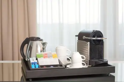 a tray with a coffee maker and cups on a table at NH Collection Brussels Centre in Brussels