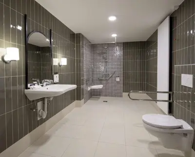 a bathroom with a toilet and a sink and a shower at DoubleTree By Hilton Brussels City in Brussels