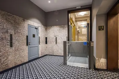 a bathroom with a glass door and a tile floor at DoubleTree By Hilton Brussels City in Brussels