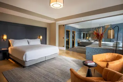 a bedroom with a large bed and a bathroom at DoubleTree By Hilton Brussels City in Brussels