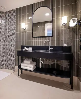 a bathroom with a black sink and a mirror at DoubleTree By Hilton Brussels City in Brussels