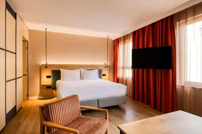 a hotel room with a bed and a chair at Hilton Garden Inn Brussels City Centre in Brussels