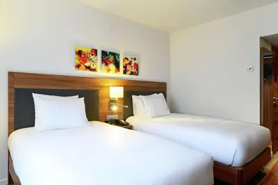 two beds sitting next to each other in a hotel room at Hilton Garden Inn Brussels City Centre in Brussels