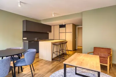 a kitchen with tables and chairs in a room at Hilton Garden Inn Brussels City Centre in Brussels