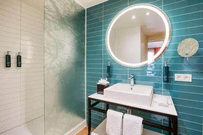 a bathroom with a sink and a mirror at Hilton Garden Inn Brussels City Centre in Brussels