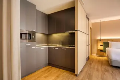 a kitchen with a sink and a bed in a room at Hilton Garden Inn Brussels City Centre in Brussels