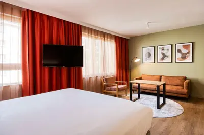 a hotel room with a bed and a couch at Hilton Garden Inn Brussels City Centre in Brussels