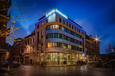 a building on a city street at night at Hotel Docklands Antwerpen in Antwerp