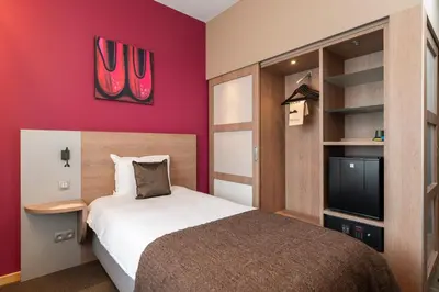 a bedroom with a bed and a flat screen tv at Van der Valk Waterloo in Waterloo