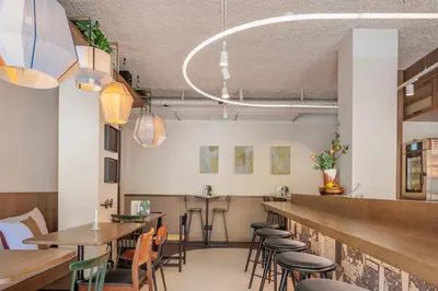 a restaurant with tables and chairs and a bar at The Usual Brussels in Brussels