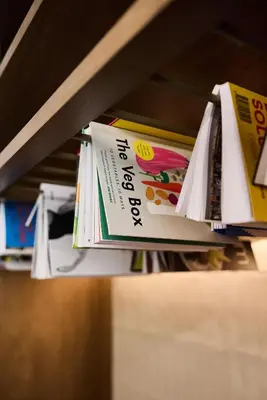 a row of books on a shelf at The Usual Brussels in Brussels